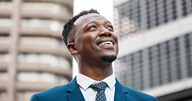Young business professional smiling and looking into the distance
