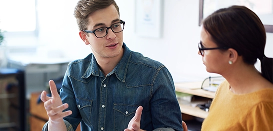 Two professionals talking together in an office