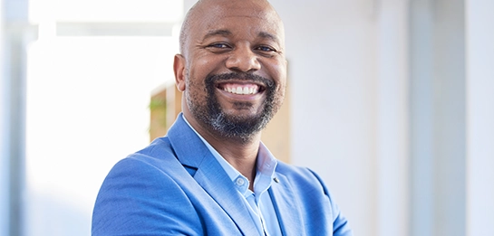 Professional standing indoors smiling