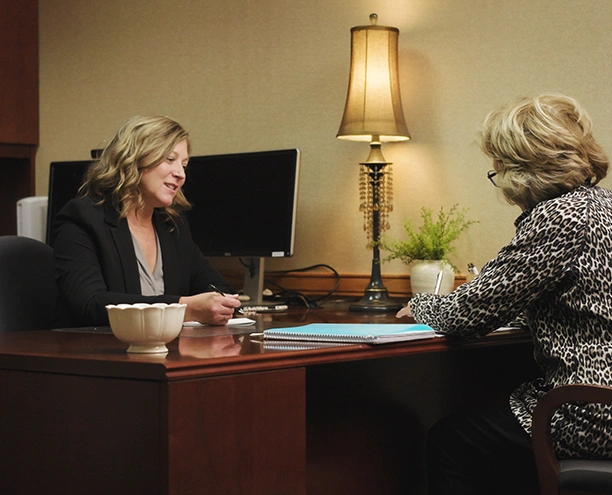Advisor meeting with client at a desk indoors
