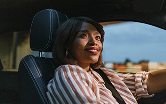 Person driving a car smiling