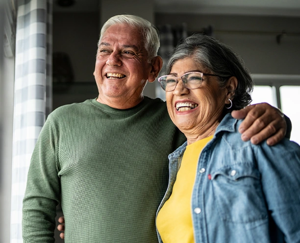 Older couple standing together indoors