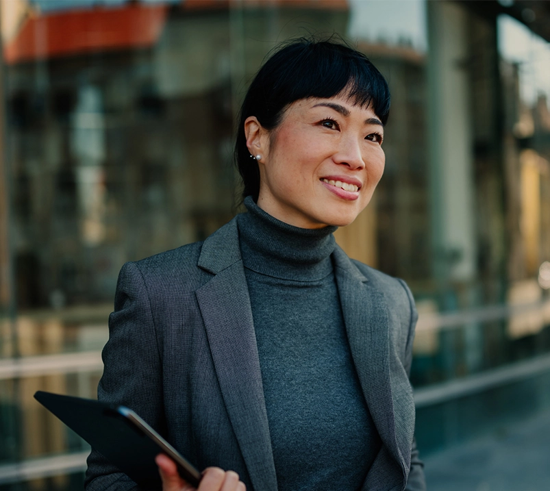 Professional woman holding a tablet and smiling