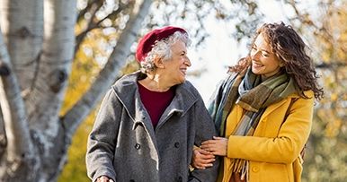 Individuals walking together outdoors, representing long-term care planning