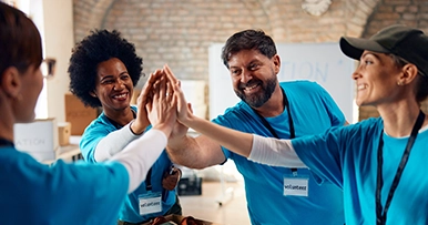 A group of volunteers high fiving