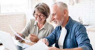 Couple reviewing documents together, representing experienced trust and estate management